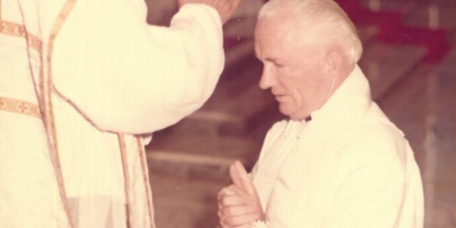 Father Luis blesses his mentor Father Frank Comerford.